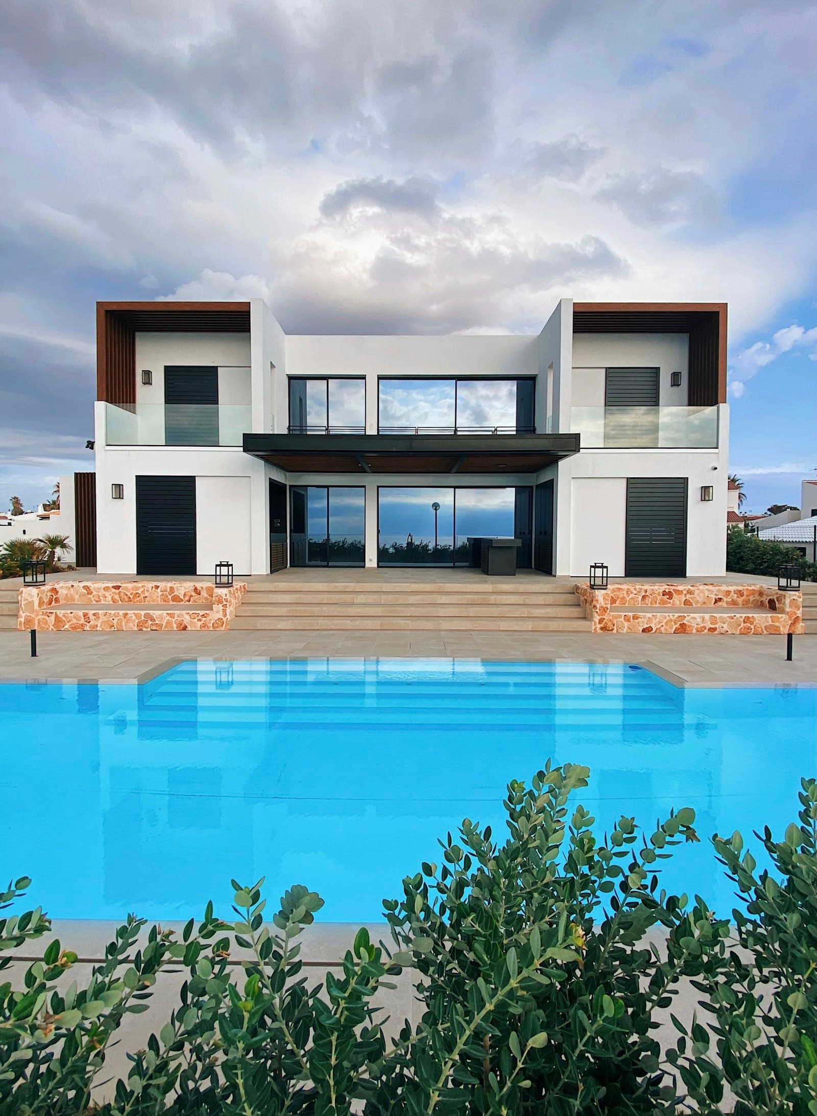 Modern villa elevation with full-height glazing onto the pool, Amazonia, Dubai